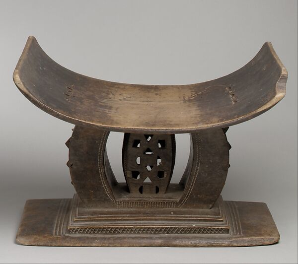 The Illusion of The Indispensable Leader A hand-carved wooden stool, a traditional African symbol of authority held in trust rather than owned.